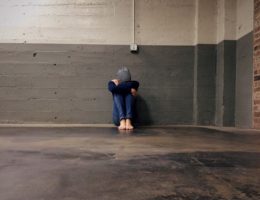 boy sitting alone in a hallway
