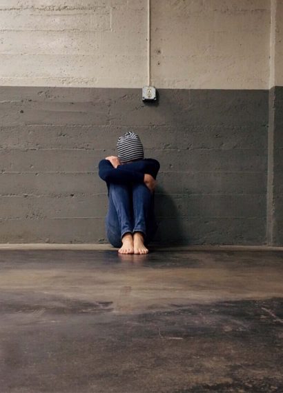 boy sitting alone in a hallway