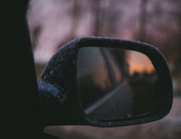 close up of a car side mirror in the snow