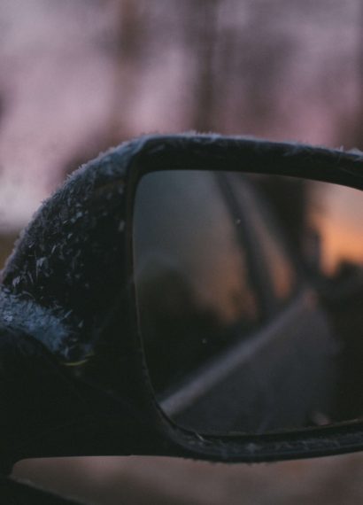 close up of a car side mirror in the snow