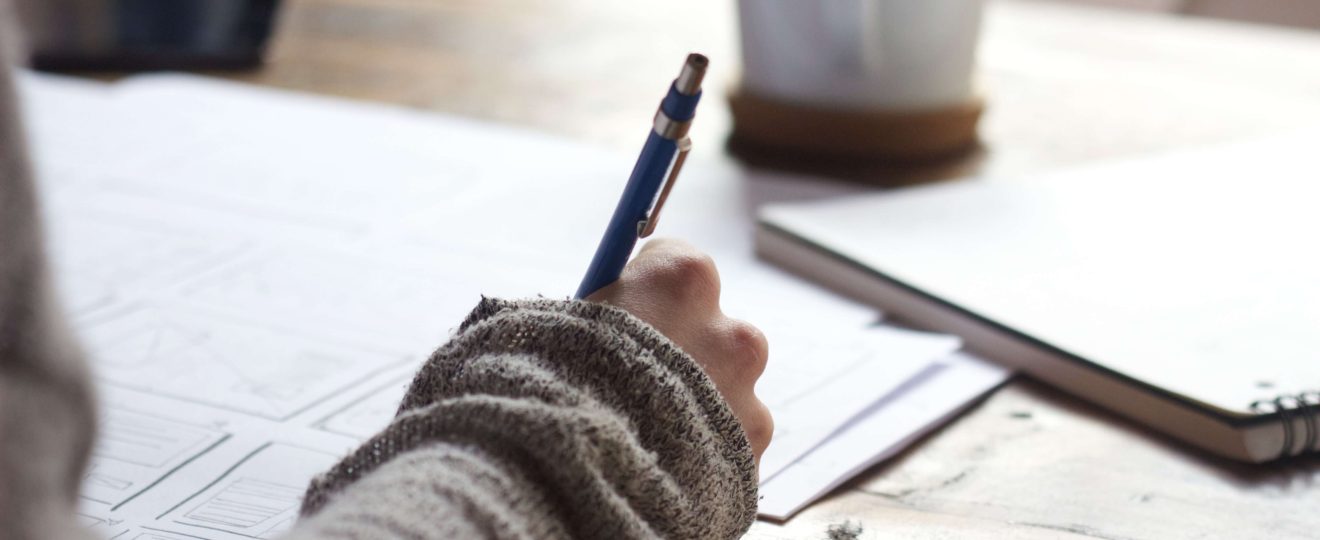 woman writing on a desk