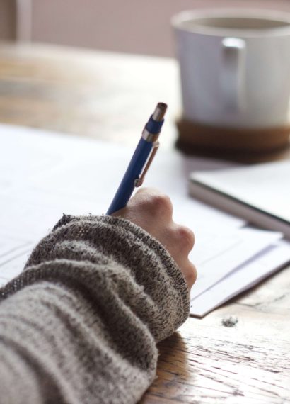 woman writing on a desk