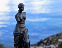 a statue of Venus de Milo near the ocean