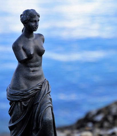 a statue of Venus de Milo near the ocean