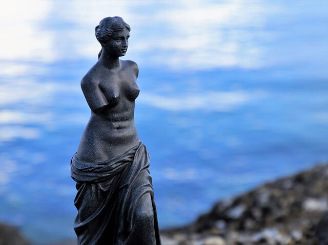 a statue of Venus de Milo near the ocean