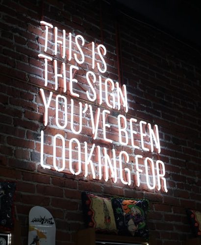 A neon sign that reads: This is the sign you've been looking for.